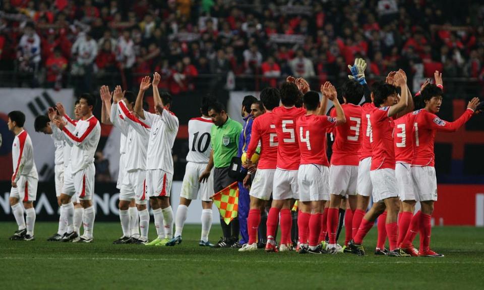 North Korea, in white, and South Korea salute the crowd in Seoul after their meeting there in April 2009.