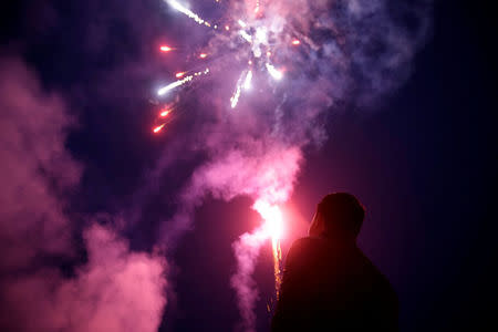 A worker watches fireworks at Liuyang Standard Fireworks Manufactory in Liuyang, Hunan province, China January 29, 2018, Picture taken January 29, 2018. REUTERS/Aly Song