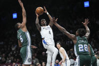 Brooklyn Nets' Edmond Sumner (4) shoots between Detroit Pistons' Alec Burks (5) and Isaiah Stewart (28) during the first half of an NBA basketball game Thursday, Jan. 26, 2023 in New York. (AP Photo/Frank Franklin II)