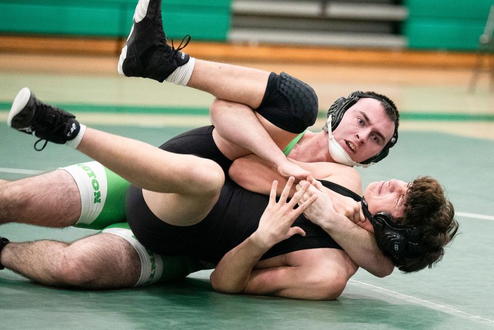 Greg Richards (top) was a four-sport athlete for the Huntington Huntsmen with wrestling being one of his favorites. He achieved his 100 wins during his senior year, which is a huge accomplishment for a wrestler during their high school career. Richards also played football and ran cross country and track.
