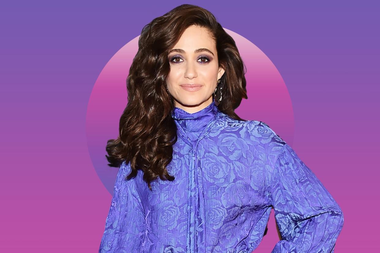 Emmy Rossum wearing her natural hair at the Amazon's Museum Of Modern Love against a purple background