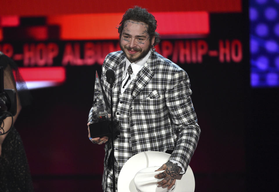 Post Malone accepts the award for favorite rap/hip-hop album for "Hollywood's Bleeding" at the American Music Awards on Sunday, Nov. 24, 2019, at the Microsoft Theater in Los Angeles. (Photo by Chris Pizzello/Invision/AP)