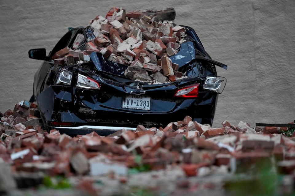 PHOTO: A car sits under fallen bricks in the aftermath of a severe thunderstorm May 17, 2024, in Houston.  (David J. Phillip/AP)