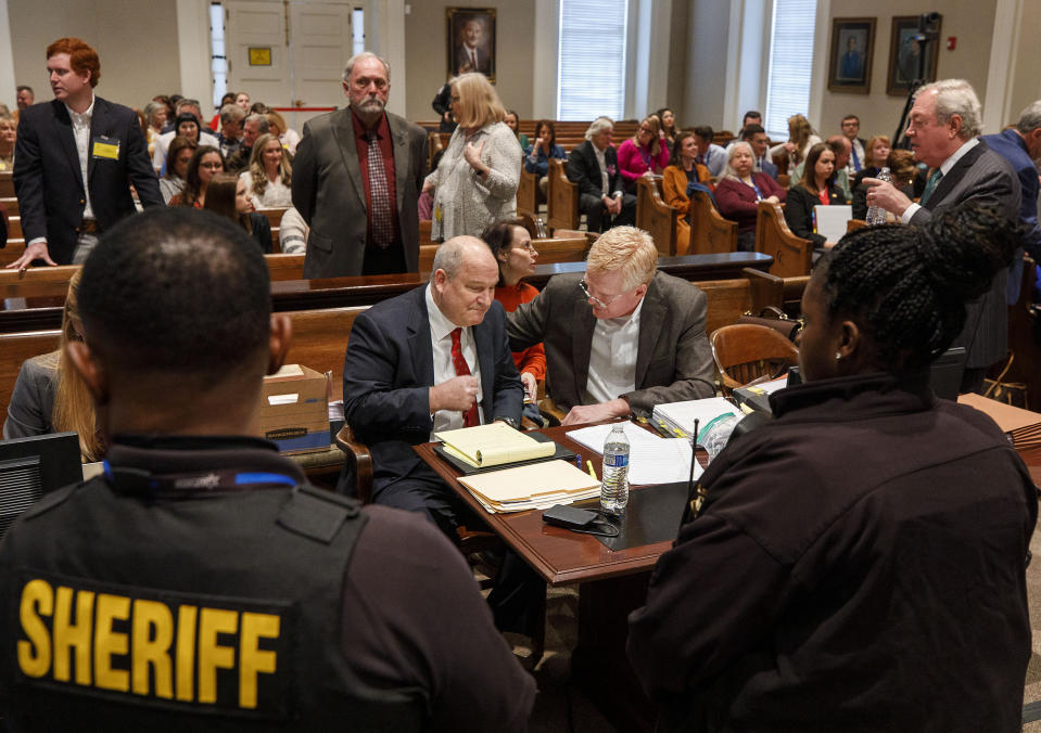 Sheriff deputies keep watch over defendant Alex Murdaugh, center right, who talks with defense attorney Jim Griffin, during Murdaugh's double murder trial at the Colleton County Courthouse in Walterboro, S.C., Friday, Jan. 27, 2023. (Grace Beahm Alford/The Post And Courier via AP, Pool)