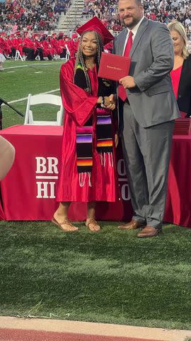 <p>Courtesy of Maria Vasquez</p> Kayleigh Craddock (L) at her Brazosport High School graduation in May 2023. She wore a Mexican heritage stole that her school district said violated graduation dress guidelines.
