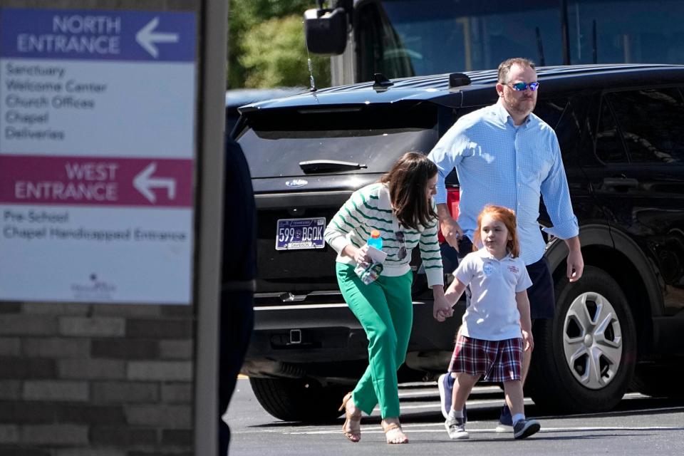 Adults walk with a child at a reunification center at the Woodmont Baptist Church after a shooting at The Covenant School, Monday, March 27, 2023, in Nashville, Tenn. (AP)