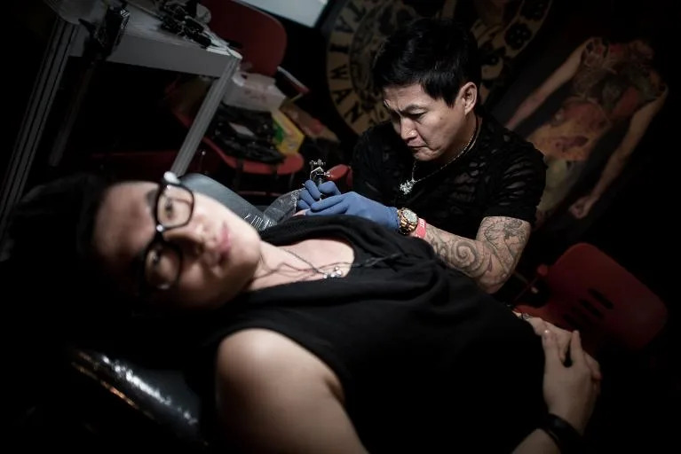 A man gets a tattoo at the Hong Kong Tattoo Convention on October 4, 2013