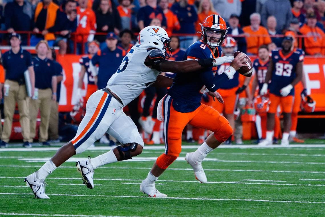 Sep 23, 2022; Syracuse, New York, USA; Virginia Cavaliers defensive end Chico Bennett Jr. (15) sacks Syracuse Orange quarterback Garrett Shrader (6) during the second half at JMA Wireless Dome. Mandatory Credit: Gregory Fisher-USA TODAY Sports Gregory Fisher/Gregory Fisher-USA TODAY Sports