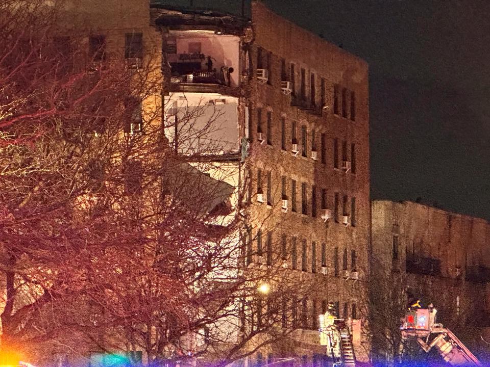 Firefighters continue to work the scene at a six-story corner of a Bronx apartment building that collapsed Monday, Dec. 11, 2023, in New York. There were no reports of injuries by early evening, but firefighters were continuing to search.