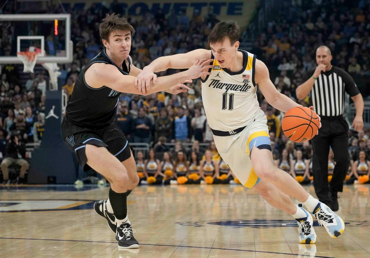 Villanova Wildcats guard Brendan Hausen (1) plays defense against Marquette Golden Eagles guard Tyler Kolek (11) during the first half of their game Monday, Jan. 15, 2024, at Fiserv Forum in Milwaukee.