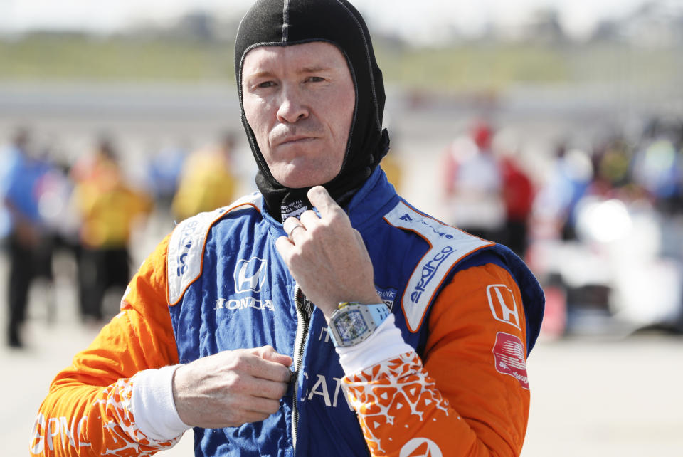 FILE - In this Friday, July 17, 2020, file photo, Scott Dixon gets ready for qualifying for an IndyCar Series auto race at Iowa Speedway in Newton, Iowa. Chip Ganassi knew Scott Dixon as a quiet kid in a paddock full of superstars when he hired him four races into the 2002 season. The pairing has since produced the most celebrated driver of his generation. (AP Photo/Charlie Neibergall, File)