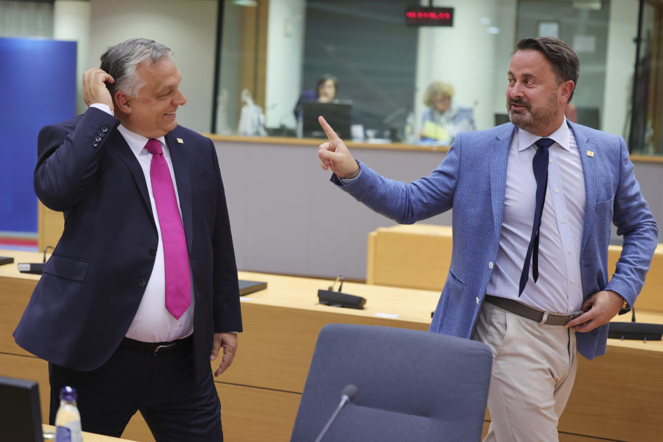 Hungarian Prime Minister Viktor Orban, left, and Luxembourg's Prime Minister Xavier Bettel talk before the an extraordinary meeting of EU leaders to discuss Ukraine, energy and food security in Brussels, Monday, May 30, 2022. European Union leaders will gather Monday in a fresh show of solidarity with Ukraine but divisions over whether to target Russian oil in a new series of sanctions are exposing the limits of how far the bloc can go to help the war-torn country. (AP Photo/Olivier Matthys)