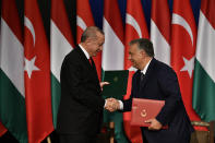Turkish President Recep Tayyip Erdogan, left, and Hungarian Prime Minister Viktor Orban shake hands during a signing ceremony in Budapest, Hungary, Thursday, Nov. 7, 2019. (Zsolt Szigetvary/MTI via AP)