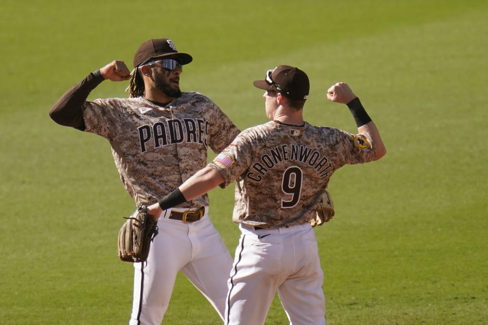 San Diego Padres shortstop Fernando Tatis Jr, left, and second baseman Jake Cronenworth (9) celebrate after they defeated the Los Angeles Dodgers in a baseball game Sunday, April 18, 2021, in San Diego. (AP Photo/Gregory Bull)