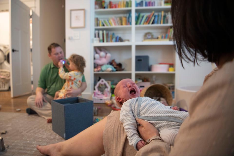 Jena Thomas holds her son, Jackson, while her husband, Josh, plays with their daughter Elyse, in their home at Nashville, Tenn., Thursday, Oct. 26, 2023. Jackson was born in the parking garage of Ascension Saint Thomas Midtown.