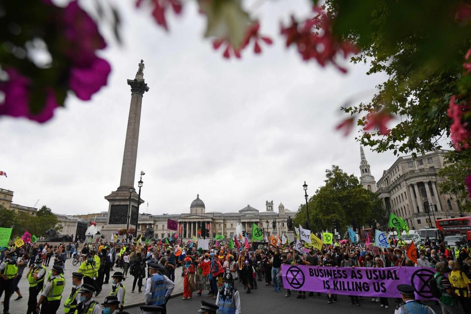 One banner read 'business as usual is killing us' (AFP via Getty Images)