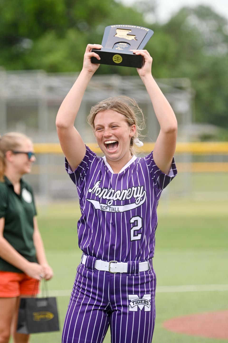 Montgomery pitcher Bryley Crayon holds up the Most Outstanding Player award that she received following her complete-game performance in the Lady Tigers’ 8-3 win over LaSalle in the Class 1A state title game on Saturday.