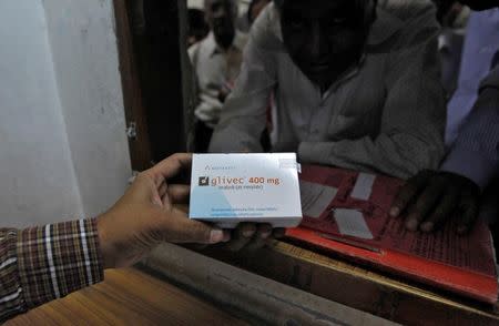 A man buys cancer drug Glivec for a relative who is suffering from cancer at a pharmacy in Ahmedabad, India April 2, 2013. REUTERS/Amit Dave