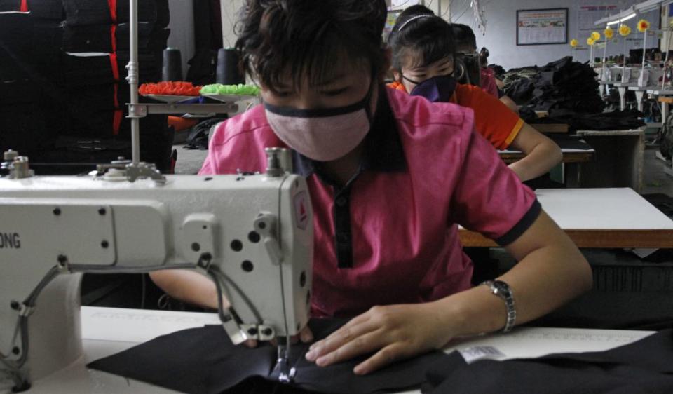 In this July 23, 2016 photo, seamstresses stitch together clothing at a factory in the Rason Special Economic Zone in North Korea. Even as North Korea is facing tough sanctions, the zone is by North Korean standards thriving. For countries spearheading efforts to impose even stronger sanctions against the North for its recent nuclear test, it's an irritating reminder that not everyone is onboard with the idea of shutting off trade with Pyongyang, especially when there is money to be made. (AP Photo/Eric Talmadge)