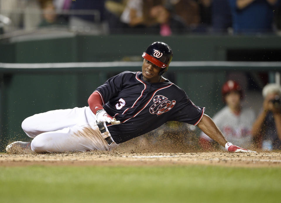 Washington Nationals outfielder Michael Taylor slides home on his inside-the-park-grand slam against the Phillies. (AP)