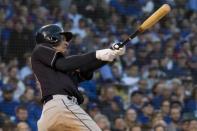 May 23, 2018; Chicago, IL, USA; Cleveland Indians left fielder Michael Brantley (23) hits an RBI single during the third inning against the Chicago Cubs at Wrigley Field. Mandatory Credit: Patrick Gorski-USA TODAY Sports