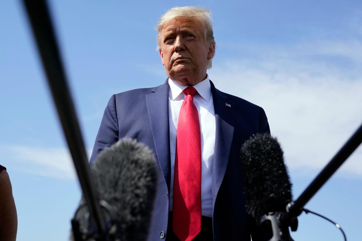 President Donald Trump talks to reporters at Phoenix Sky Harbor International Airport, Monday, Oct. 19, 2020, in Phoenix.