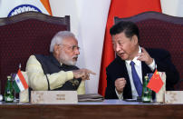 FILE- Indian Prime Minister Narendra Modi, left, talks with Chinese President Xi Jinping at a signing ceremony by foreign ministers during the BRICS summit in Goa, India, Oct. 16, 2016. (AP Photo/Manish Swarup, File)