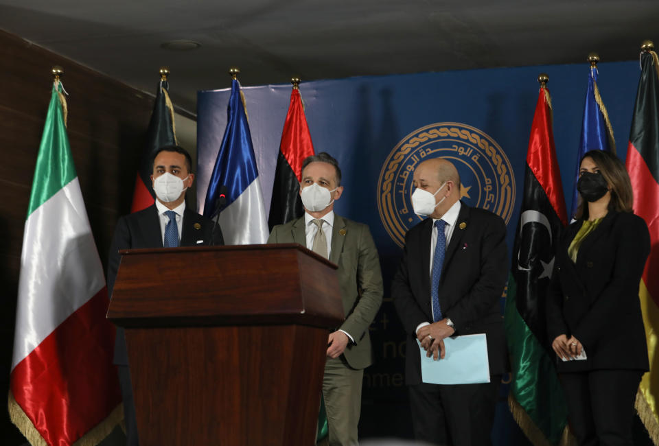 ADDS NAME OF LIBYAN FOREIGN MINISTER NAJLA EL-MANGOUSH - The foreign ministers of Italy, Germany, France and Libya, from Left to right, Italian Foreign Minister Luigi Di Maio, German Foreign Minister Heiko Maas, French Foreign Affairs Minister Jean-Yves Le Drian, and Libyan Foreign Minister, Najla el-Mangoush, take the stage, in Tripoli, Libya, Thursday, March 25, 2021. The foreign ministers of France, Italy and Germany arrived Thursday in Tripoli to show their support to Libya's newly elected transitional authorities, who are expected to lead the war-stricken country through general elections end of 2021. (AP Photo/Hazem Ahmed)