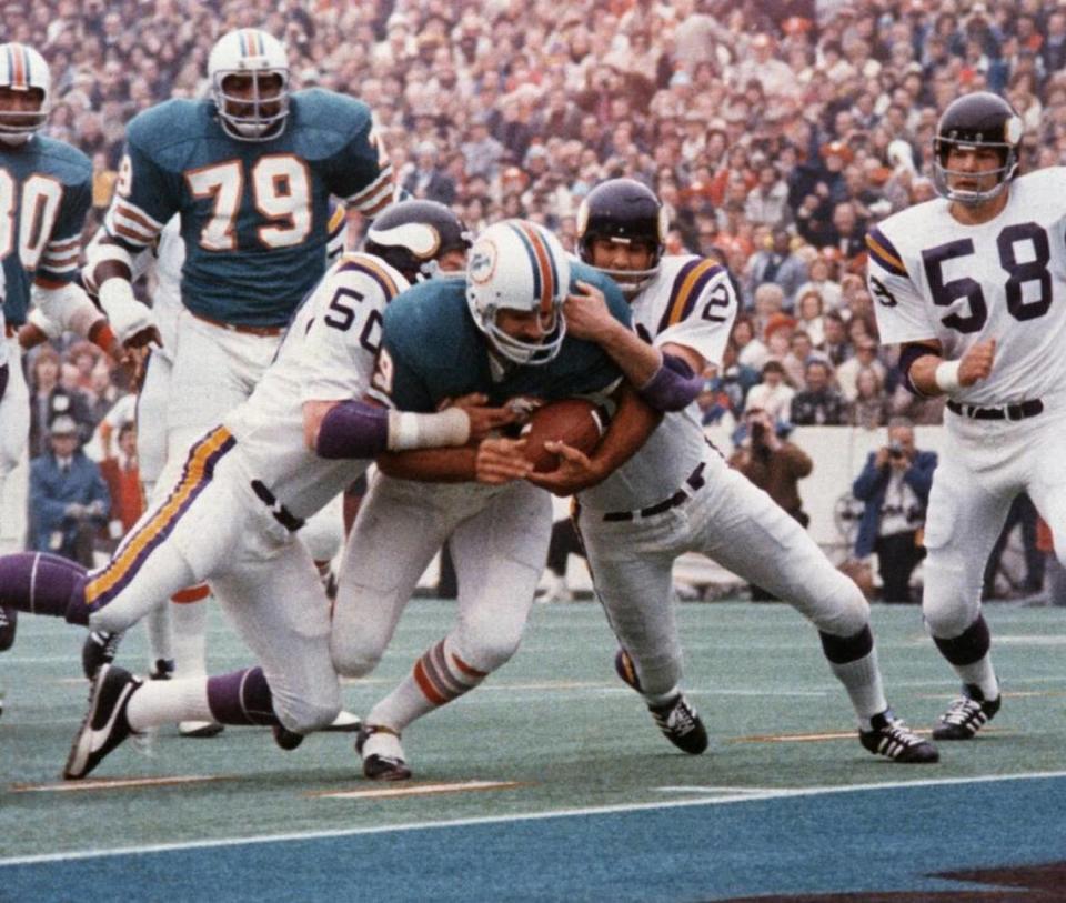 Dolphins fullback Larry Csonka plows between Vikings LB Jeff Siemon (50) and safety Paul Krause for one of his two touchdowns in the Dolphins’ 24-7 Super Bowl VIII win.