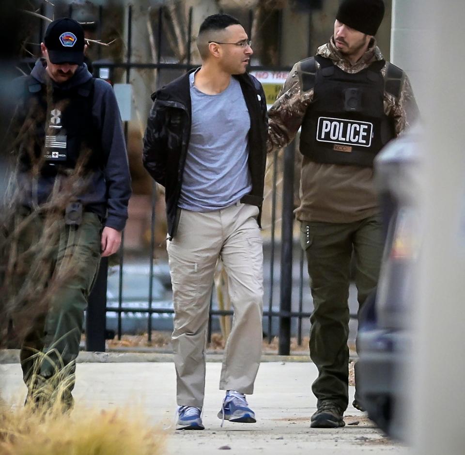 Solomon Pena, center, a Republican candidate for New Mexico House District 14, is taken into custody by Albuquerque Police officers, Monday, Jan. 16, 2023, in southwest Albuquerque, N.M. Pena was arrested in connection with a recent series of drive-by shootings targeting Democratic lawmakers in New Mexico.