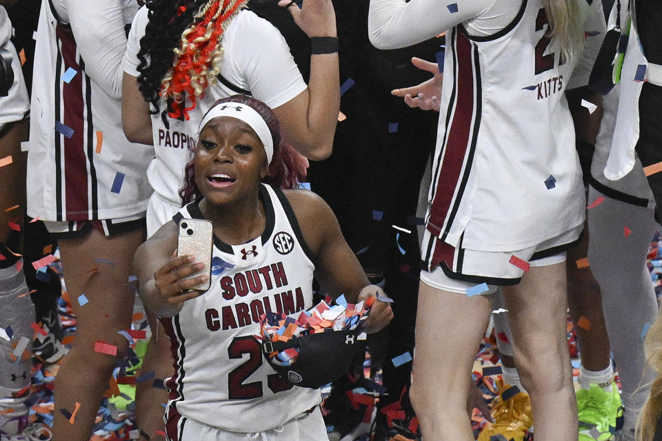 South Carolina guard Bree Hall (23) takes a selfie on the court after defeating Oregon State in an Elite Eight round college basketball game during the NCAA Tournament, Sunday, March 31, 2024, in Albany, N.Y. (AP Photo/Hans Pennink)