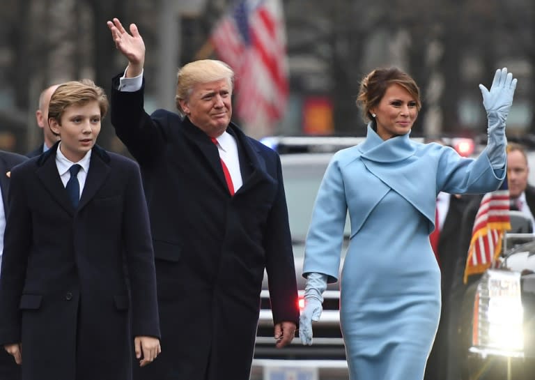 US President Donald Trump and First Lady Melania Trump walk the inaugural parade route with son Barron on Pennsylvania Avenue in Washington, DC