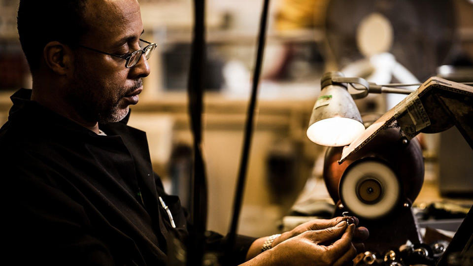 A jeweler polishes a Deakin & Francis signet ring.