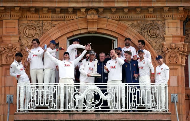 Feroze Khushi, far left, recoils after beer is poured on him during the Bob Willis Trophy presentation