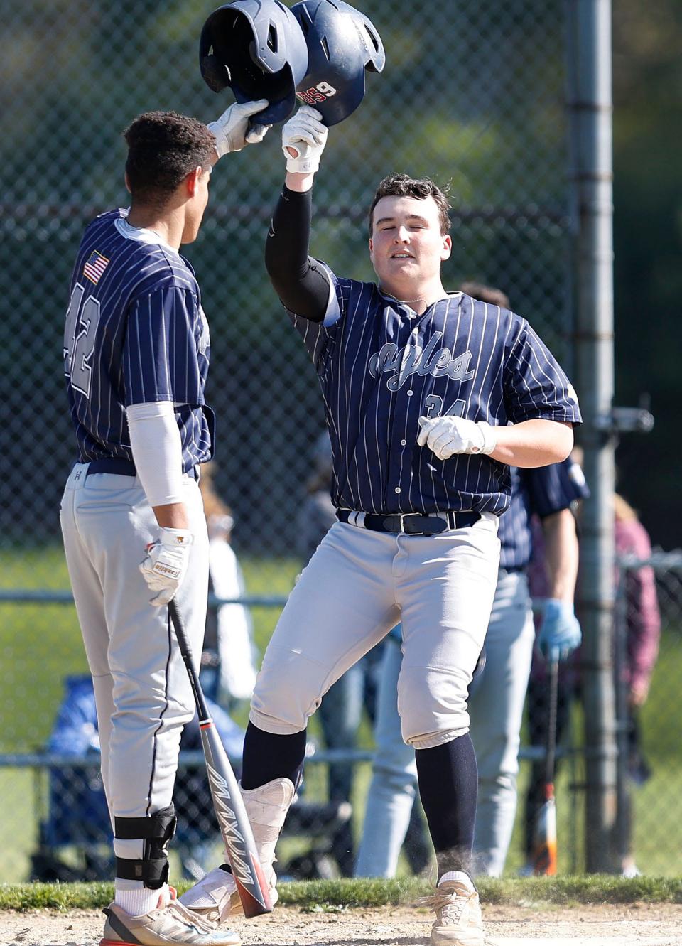 Plymouth North's George Slauson (34) celebrates a home run with on deck batter DC Brown. Silver Lake Regional hosted Plymouth North in baseball action on Monday May 13, 2024