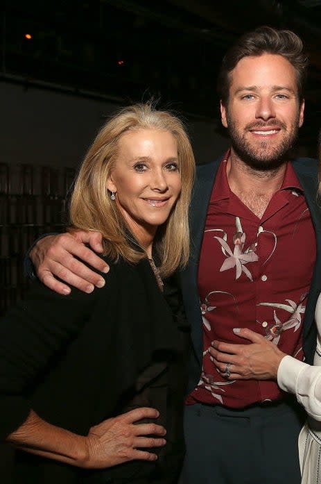 Armie with his arm around his mother's shoulder