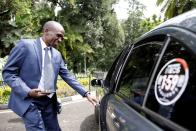 Kipchoge, the marathon world record holder, enters a car after an Interview with Reuters at the state house in Nairobi