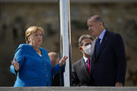 German Chancellor Angela Merkel, left, talks to Turkish President Recep Tayyip Erdogan during their meeting at Huber Villa presidential palace, in Istanbul, Turkey, Saturday, Oct. 16, 2021. (AP Photo/Francisco Seco)