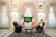 Iran's outgoing President Rouhani meets with the Iran's President-elect Raisi in Tehran