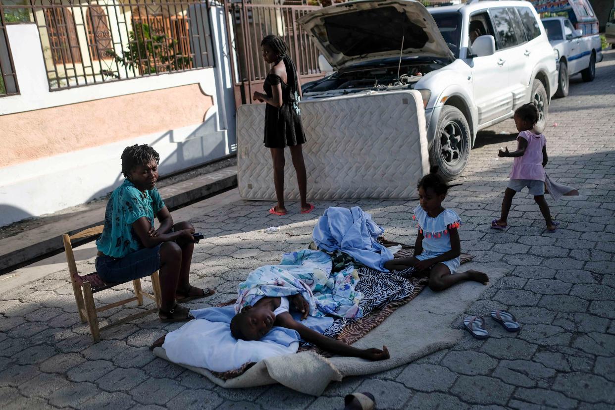 Residents stay outside their homes amid the fear of aftershocks in Saint-Louis-du-Sud, Haiti, early Monday, Aug. 16, 2021, two days after a 7.2-magnitude earthquake struck the southwestern part of the country.