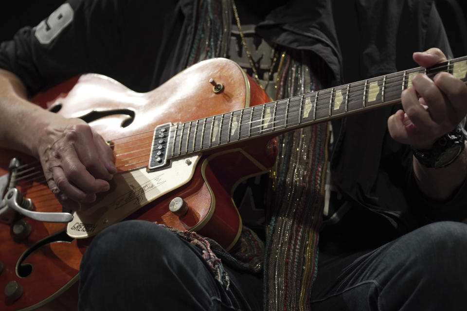 Canadian rock legend Randy Bachman plays a Gretsch guitar, which was stolen in 1977, after he was reunited with it during the Lost and Found Guitar Exchange Ceremony Friday, July 1, 2022, at Canadian Embassy in Tokyo. Bachman’s long-held dream came true Friday when he was reunited in Tokyo with a beloved guitar nearly a half-century after it was stolen from a Toronto hotel. Bachman, 78, a former member of The Guess Who, received the guitar from a Japanese musician who had bought it at a Tokyo store in 2014 without knowing its history. (AP Photo/Eugene Hoshiko)