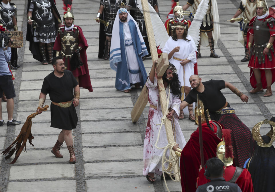 Residents reenact the crucifixion of Jesus Christ in the Passion Play of Iztapalapa, outside the Cathedral, on the outskirts of Mexico City, Friday, April 2, 2021, amid the new coronavirus pandemic. To help prevent the spread of the COVID-19, Latin America's most famous re-enactment of the crucifixion of Christ was closed to the public and transmitted live so people could watch at home, for a second consecutive year. (AP Photo/Marco Ugarte)