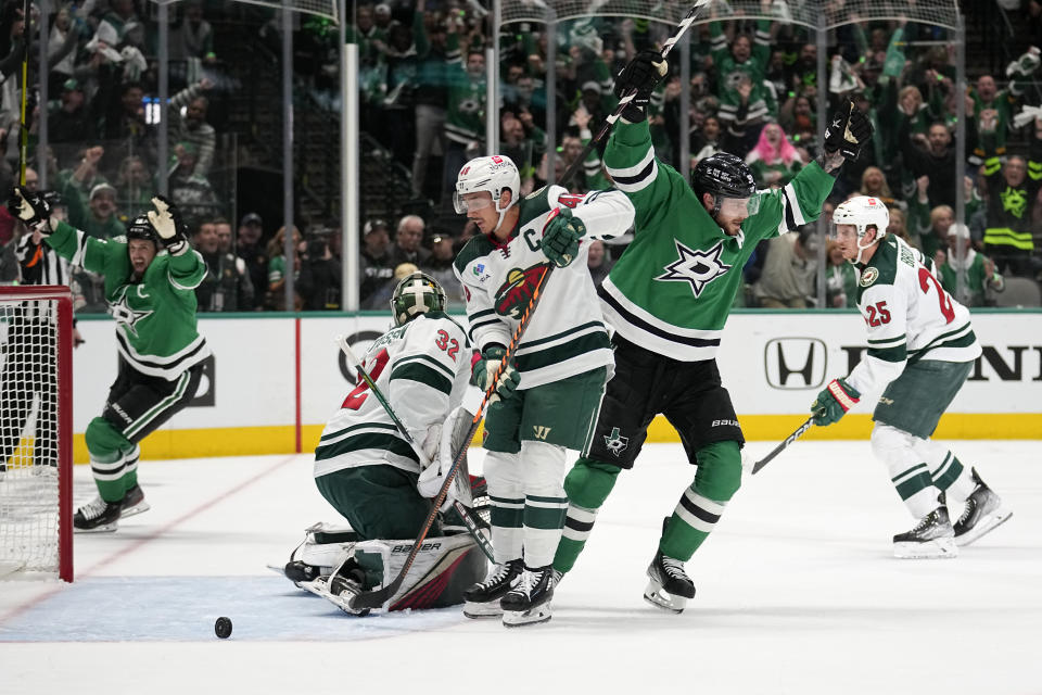 Dallas Stars center Tyler Seguin, center, and Jamie Benn, left, celebrate after Jason Robertson scored against the Minnesota Wild during the first period of Game 5 of an NHL hockey Stanley Cup first-round playoff series, Tuesday, April 25, 2023, in Dallas. (AP Photo/Tony Gutierrez)