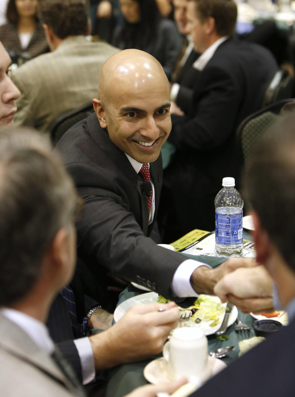 Neel Kashkari, a former U.S. Treasury official, shakes hands with Greg Mellor, right, before giving the keynote speech before the California Business Review where he announced that he would run for governor of California, at California State University, Sacramento, Tuesday, Jan. 21, 2014, in Sacramento, Calif. Kashkari, a political newcomer and Republican, faces long odds against incumbent Gov. Jerry Brown. (AP Photo/Rich Pedroncelli)