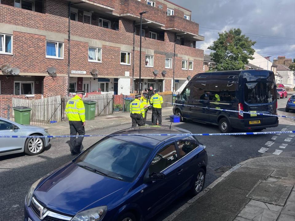 Police officers work at the scene in Woolwich where a boy was stabbed to death on Sunday (The Independent)