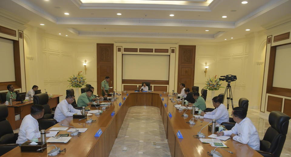In this photo from The Military True News Information Team, Senior Gen. Min Aung Hlaing, center left, chairman of State Administration Council, speaks with members the National Defense and Security Council including Myint Swe, center, Pro Temporary President of the military government, and Vice President Henry Van Thio, center right, Monday, July 31, 2023, in Naypyitaw, Myanmar. Myanmar’s military-controlled government has extended the state of emergency it imposed when the army seized power from an elected government 2 1/2 years ago, forcing a further delay in elections it promised when it took over. (The Military True News Information Team via AP)