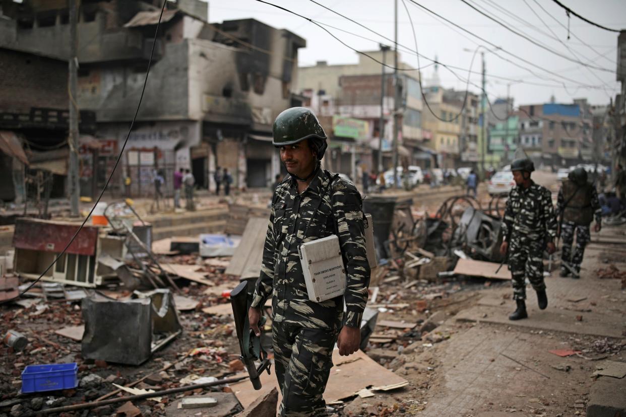 Indian paramilitary soldiers patrol streets vandalised in the religious violence on Thursday in Delhi: AP