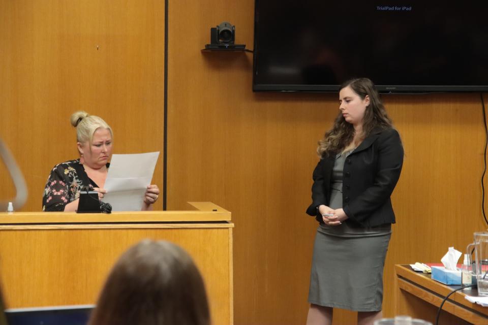 Stacey Brodie, Dee Warner's massage therapist, reviews a document presented by Marisa Vinsky, one of Dale Warner's attorneys, Friday, May 3, 2024, in Lenawee County District Court. This was the third day of a preliminary interaction into the murder and evidence tampering charges against Warner in the disappearance of his wife, Dee.