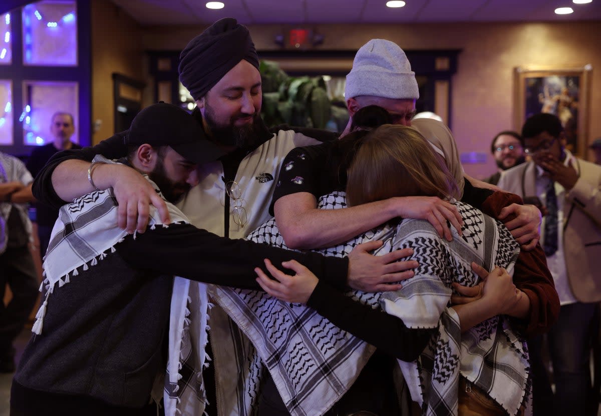 Attendees console each other during an "Uncommitted for Joe Biden" primary election night watch party at Adonis restaurant on February 27, 2024 in Dearborn, Michigan.  (Getty Images)