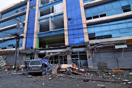 Debris falls on a car after a strong earthquake hit Surigao city, southern Philippines February 11, 2017. REUTERS/Stringer